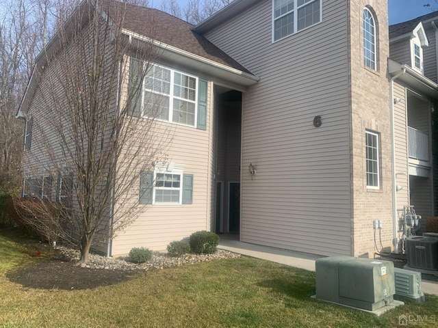 1156 Morning Glory Dr, Monroe, NJ 08831 - rear view of house with central air condition unit, a yard, and brick siding