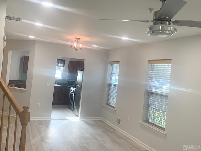 1156 Morning Glory Dr, Monroe, NJ 08831 - kitchen with appliances with stainless steel finishes, light wood-type flooring, baseboards, and dark brown cabinetry