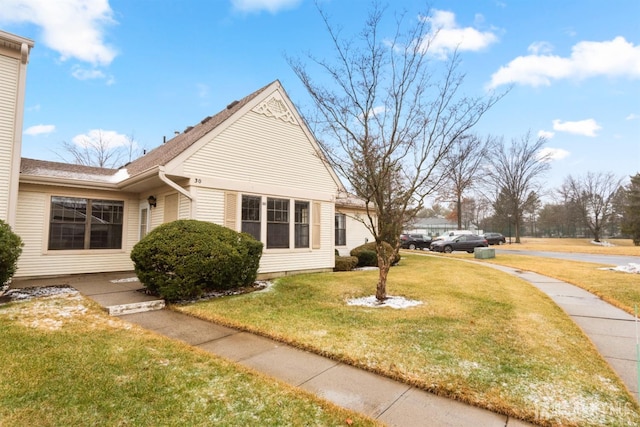 view of property exterior with a yard