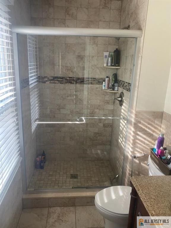 100 Neilly Ct Unit 100, Old Bridge, NJ 08857 - bathroom with toilet, vanity, tile walls, and a shower stall