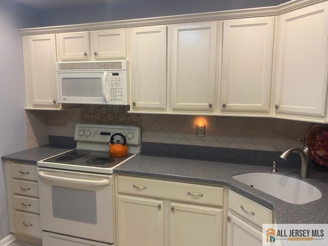 100 Neilly Ct Unit 100, Old Bridge, NJ 08857 - kitchen with white appliances, a sink, dark countertops, and tasteful backsplash
