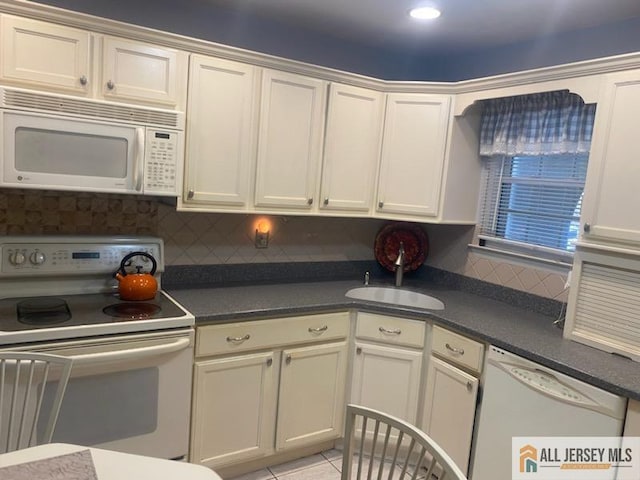 100 Neilly Ct Unit 100, Old Bridge, NJ 08857 - kitchen featuring white appliances, a sink, tasteful backsplash, dark countertops, and light tile patterned floors