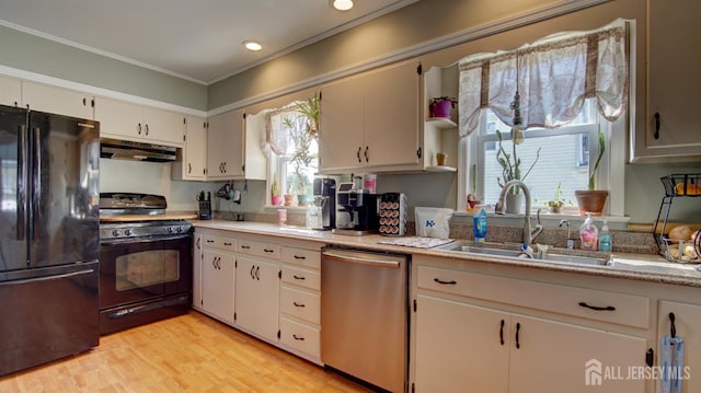 110 N Pine Ave, South Amboy, NJ 08879 - kitchen featuring black appliances, under cabinet range hood, light countertops, plenty of natural light, and ornamental molding