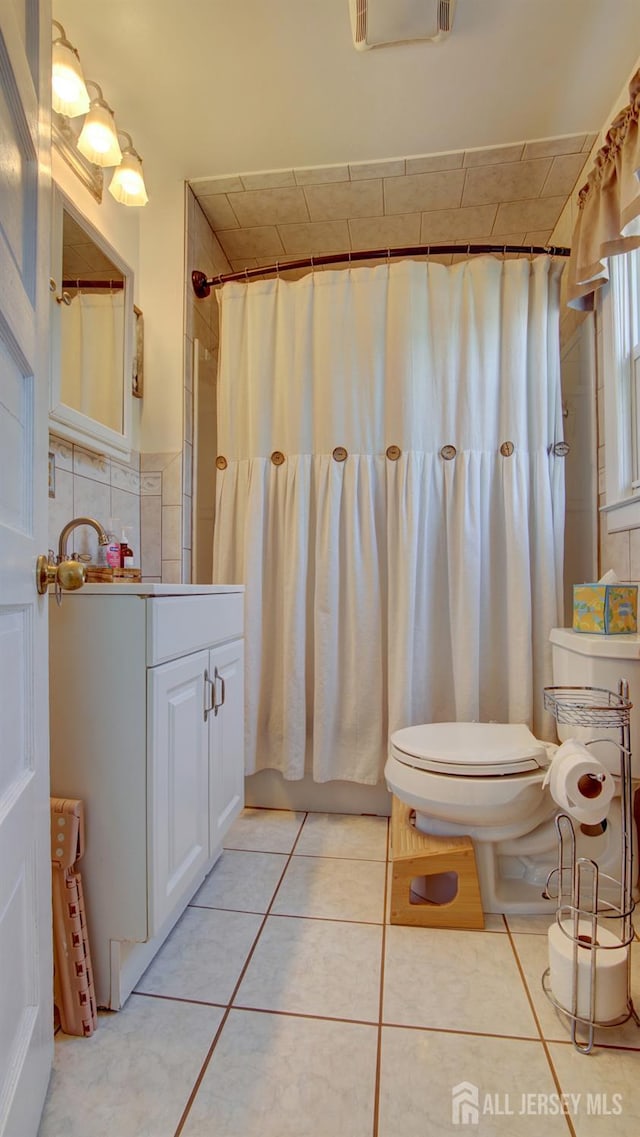 110 N Pine Ave, South Amboy, NJ 08879 - bathroom with tile patterned flooring, tile walls, vanity, and curtained shower