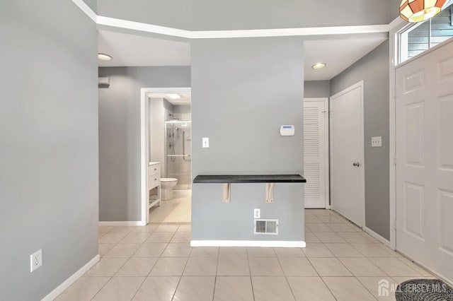 interior space with visible vents, baseboards, and light tile patterned flooring