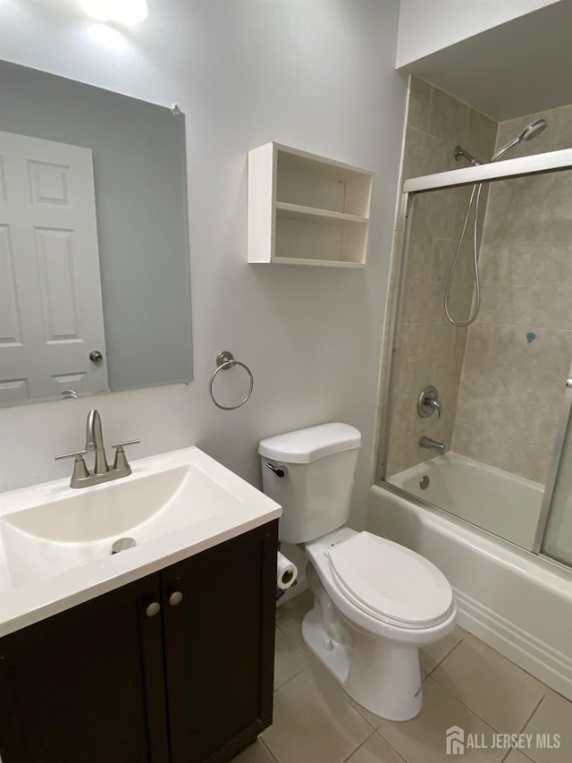 full bathroom featuring bath / shower combo with glass door, vanity, toilet, and tile patterned flooring