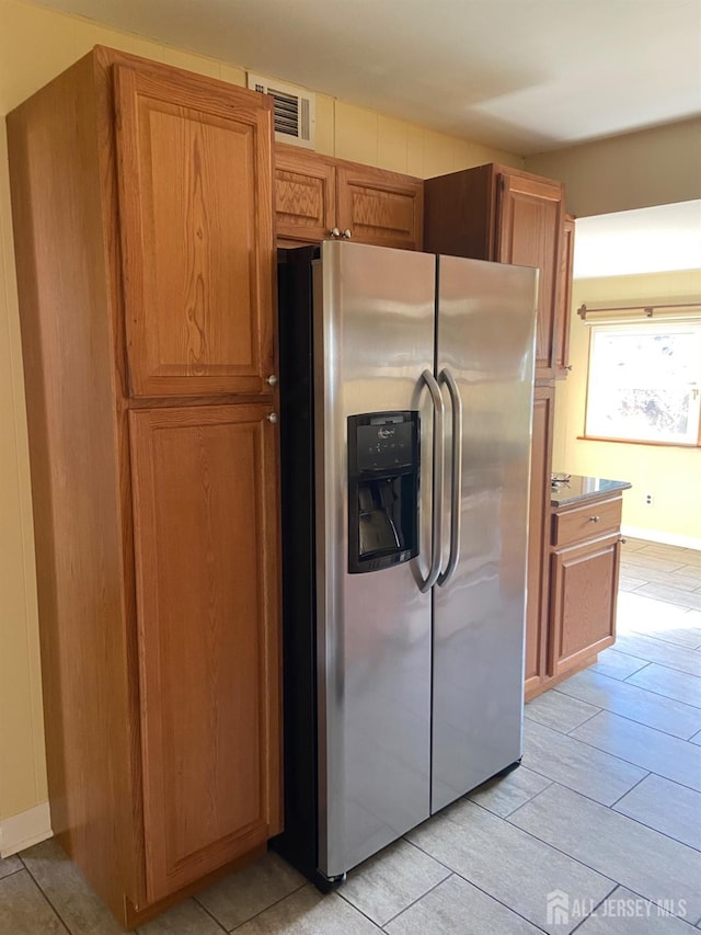 kitchen featuring stainless steel fridge with ice dispenser