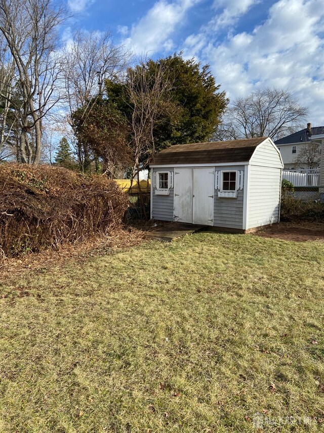 view of outbuilding with a lawn