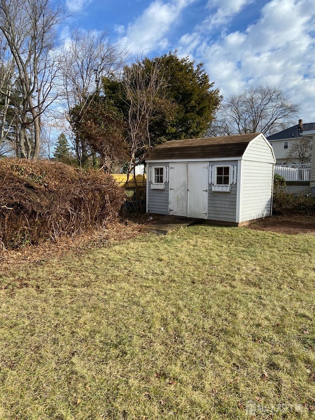 view of outdoor structure featuring a lawn