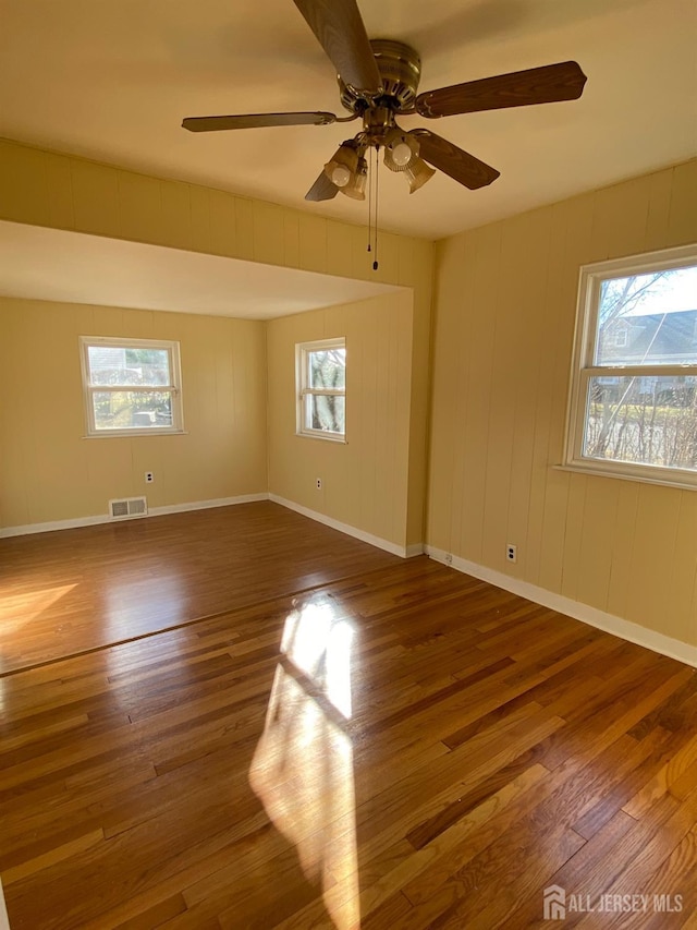 spare room with dark wood-type flooring and ceiling fan