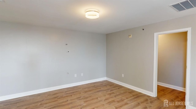 unfurnished room featuring visible vents, baseboards, and light wood finished floors