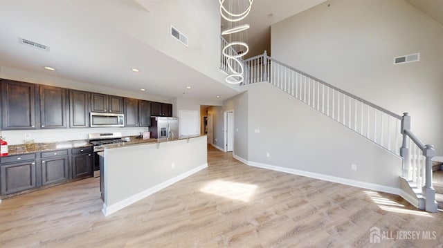 kitchen with light wood finished floors, visible vents, and appliances with stainless steel finishes