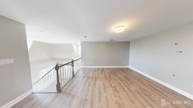 empty room featuring light wood-style floors and baseboards