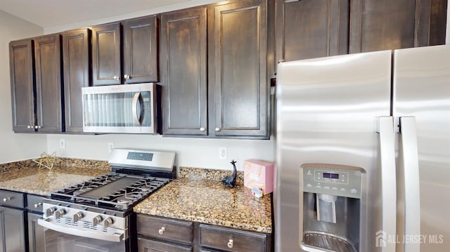 kitchen with dark brown cabinetry, stainless steel appliances, and light stone counters