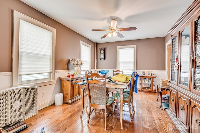 127 Hill St, Highland Park, NJ 08904 - dining room with wainscoting, a ceiling fan, and light wood-type flooring