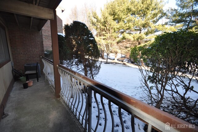 view of snow covered back of property