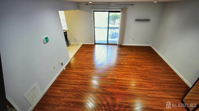 unfurnished room with hardwood / wood-style floors