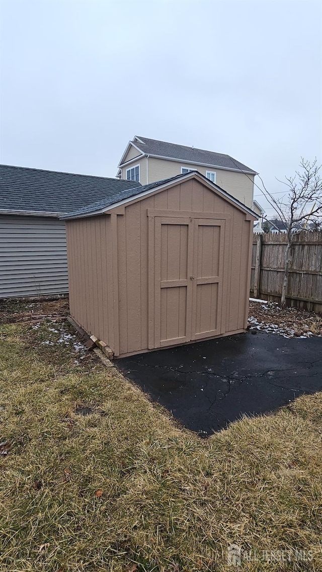 view of shed with fence