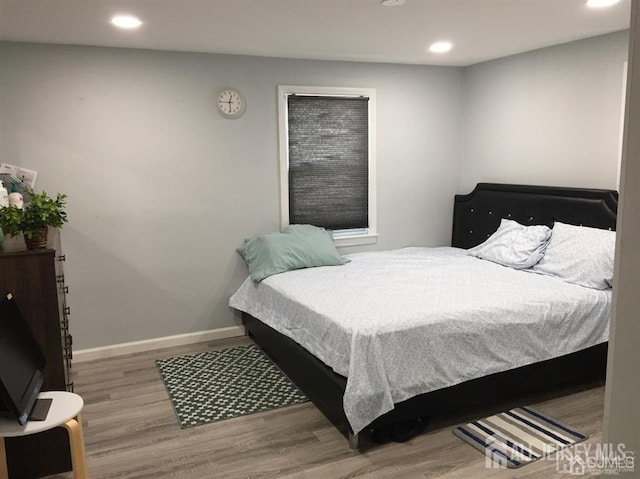 bedroom featuring recessed lighting, baseboards, and wood finished floors