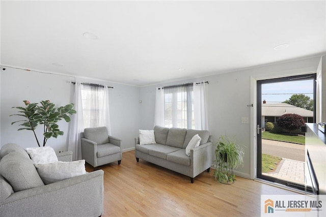 living room featuring light wood-style flooring and baseboards