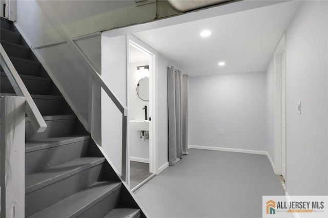below grade area featuring baseboards and recessed lighting