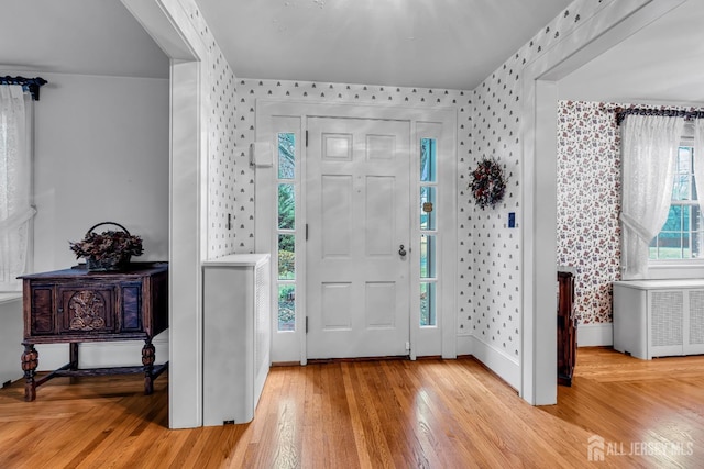 entrance foyer featuring light wood-type flooring and radiator