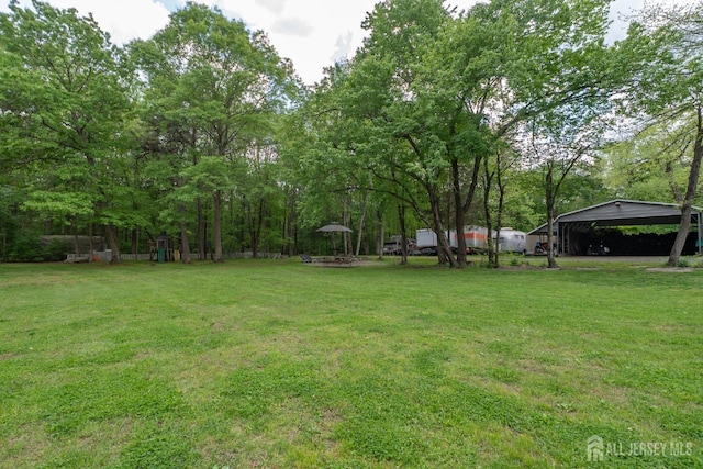 144 E Greystone Rd Unit 146, Old Bridge, NJ 08857 - view of green lawn featuring a detached carport