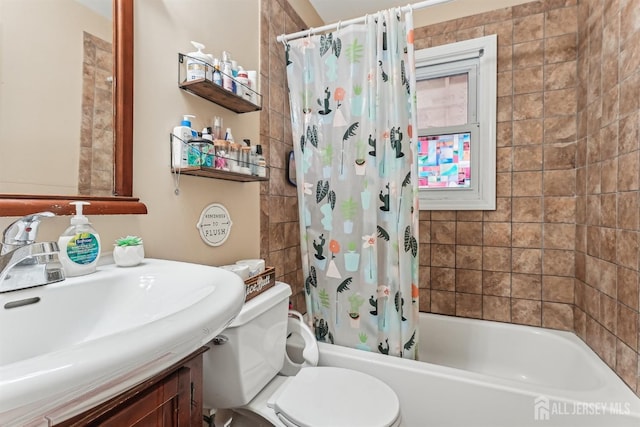 full bath featuring toilet, vanity, and shower / bathtub combination with curtain