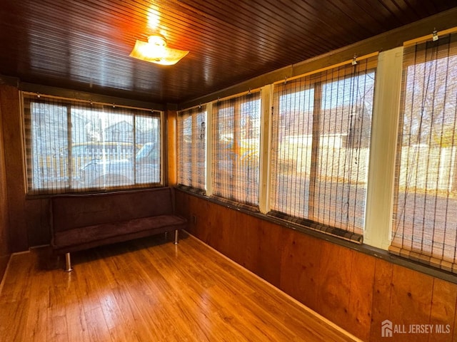 unfurnished sunroom with wood ceiling