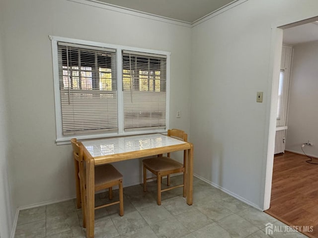 dining room featuring baseboards and ornamental molding