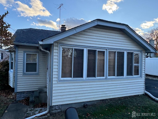 rear view of property with a sunroom