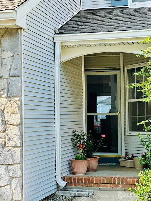 91 Heather Ct, South Brunswick, NJ 08852 - view of exterior entry with a shingled roof and stone siding