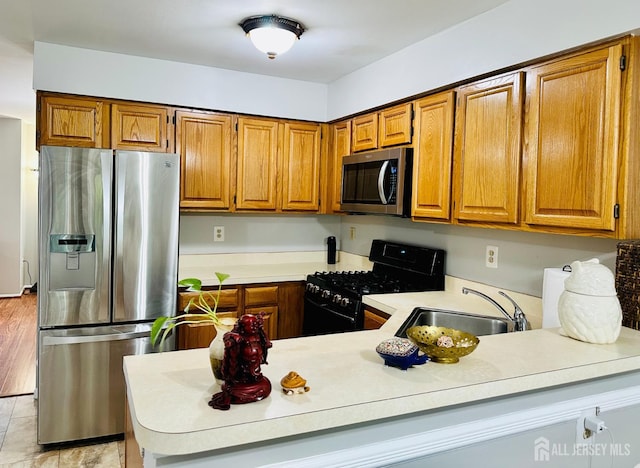 91 Heather Ct, South Brunswick, NJ 08852 - kitchen featuring stainless steel appliances, light countertops, brown cabinetry, and a peninsula