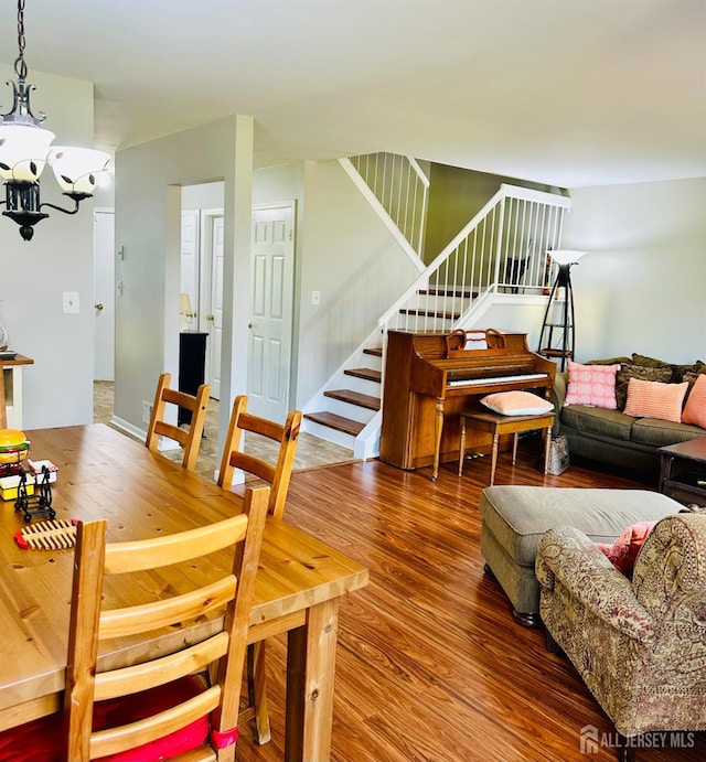 91 Heather Ct, South Brunswick, NJ 08852 - dining space featuring stairway, wood finished floors, and a chandelier