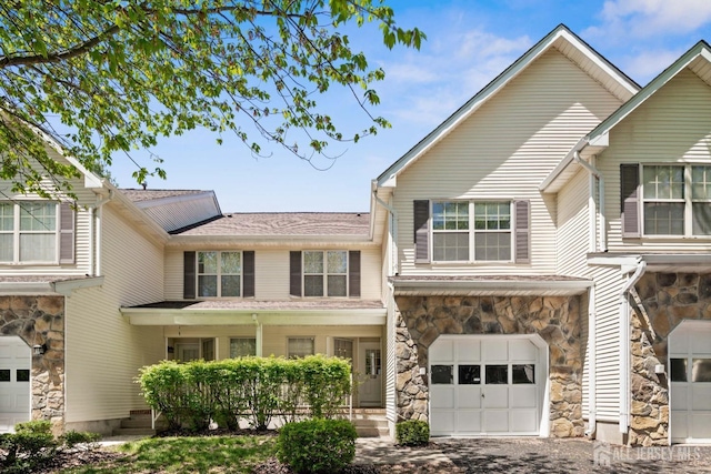 204 Concord Pl, North Brunswick, NJ 08902 - townhome / multi-family property featuring stone siding, an attached garage, and roof with shingles