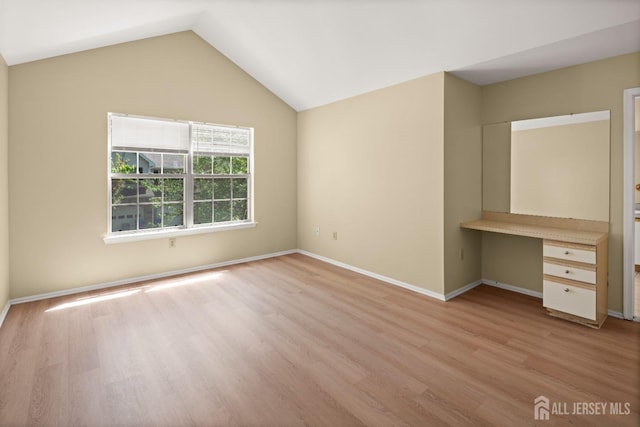 204 Concord Pl, North Brunswick, NJ 08902 - unfurnished bedroom with built in desk, light wood-style floors, and vaulted ceiling