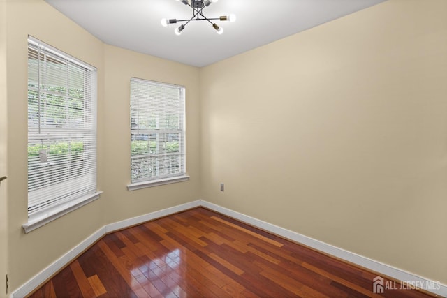 204 Concord Pl, North Brunswick, NJ 08902 - spare room featuring a chandelier and dark wood-style flooring