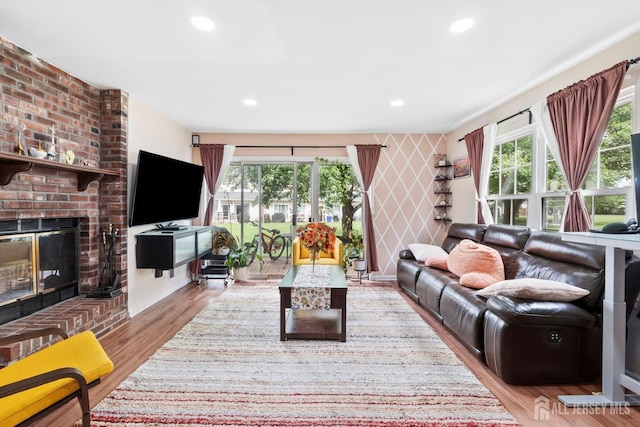 372 Mcdowell Dr, East Brunswick, NJ 08816 - living area with plenty of natural light, wood finished floors, a brick fireplace, recessed lighting, and an accent wall