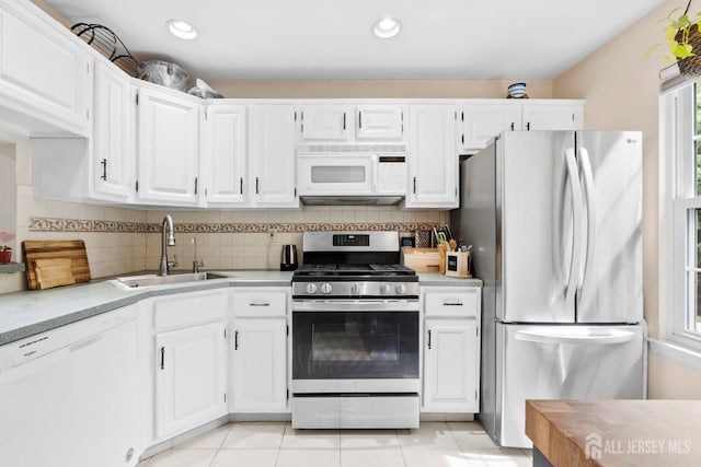 372 Mcdowell Dr, East Brunswick, NJ 08816 - kitchen with appliances with stainless steel finishes, light countertops, white cabinets, decorative backsplash, and recessed lighting