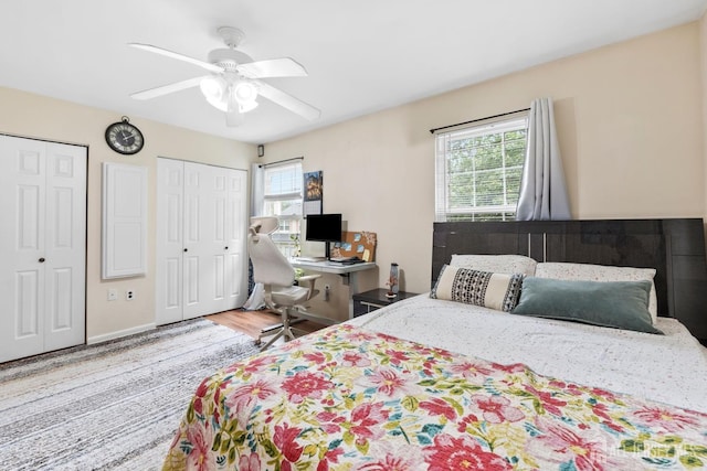 372 Mcdowell Dr, East Brunswick, NJ 08816 - bedroom with multiple closets, multiple windows, wood finished floors, and a ceiling fan