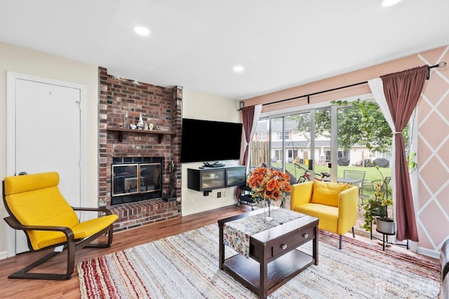 372 Mcdowell Dr, East Brunswick, NJ 08816 - living area featuring wood finished floors, a brick fireplace, and recessed lighting