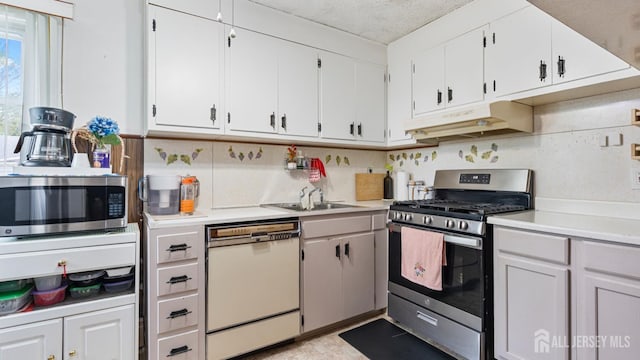 149 Ethel St, Menlo Park Terrace, NJ 08840 - kitchen with stainless steel appliances, under cabinet range hood, a sink, and light countertops