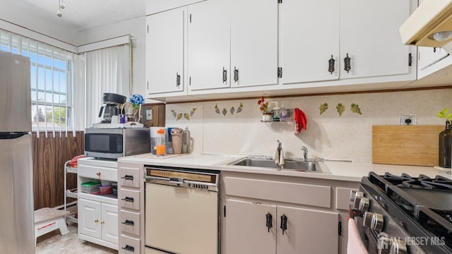 149 Ethel St, Menlo Park Terrace, NJ 08840 - kitchen featuring stainless steel appliances, light countertops, a sink, range hood, and white cabinetry