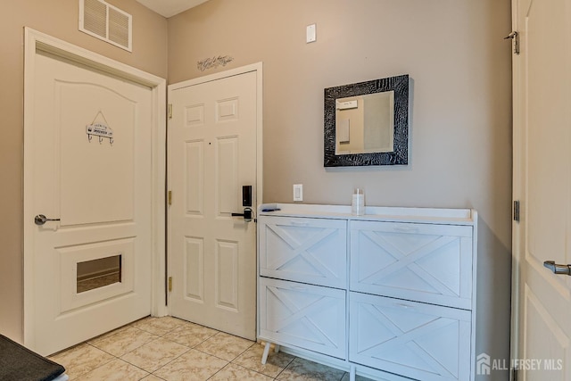 foyer entrance featuring visible vents and light tile patterned floors