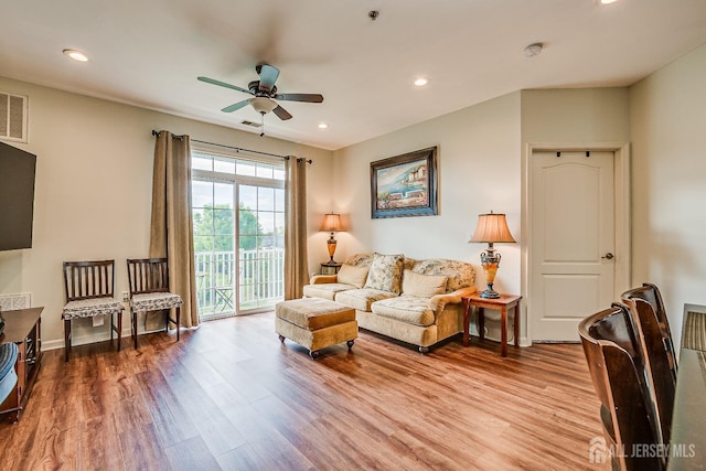 living area with a ceiling fan, recessed lighting, and wood finished floors