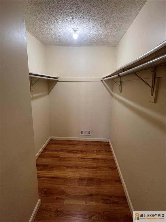 spacious closet with visible vents and wood finished floors