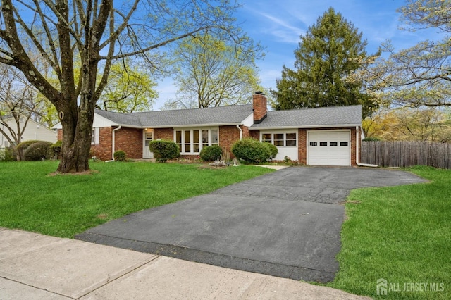 ranch-style home featuring an attached garage, brick siding, asphalt driveway, a chimney, and a shingled roof