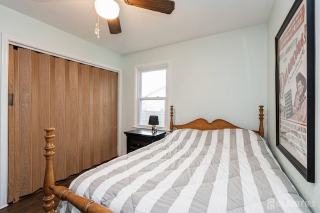 bedroom featuring a closet, wood finished floors, and ceiling fan