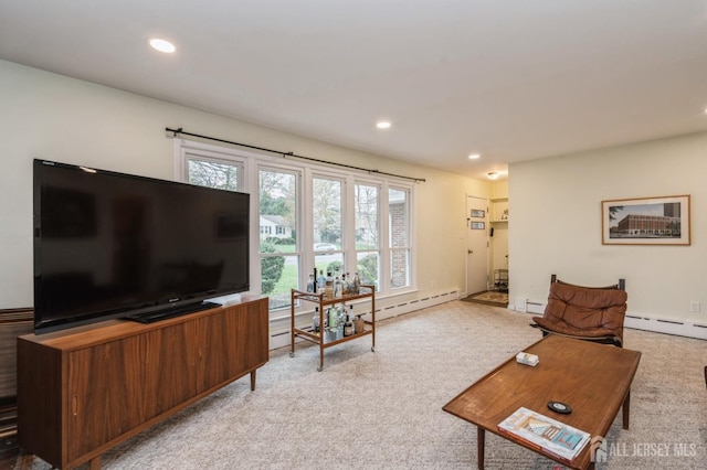 living area with light colored carpet, a baseboard heating unit, and recessed lighting