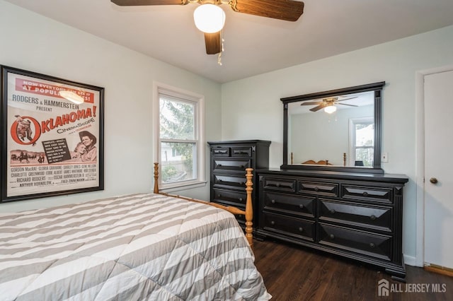 bedroom featuring wood finished floors, multiple windows, and a ceiling fan